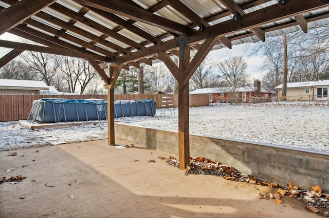 snow covered patio with a covered pool