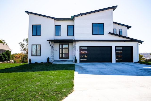 view of front facade featuring a garage and a front lawn