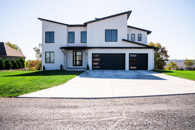 modern farmhouse style home featuring a front yard and a garage