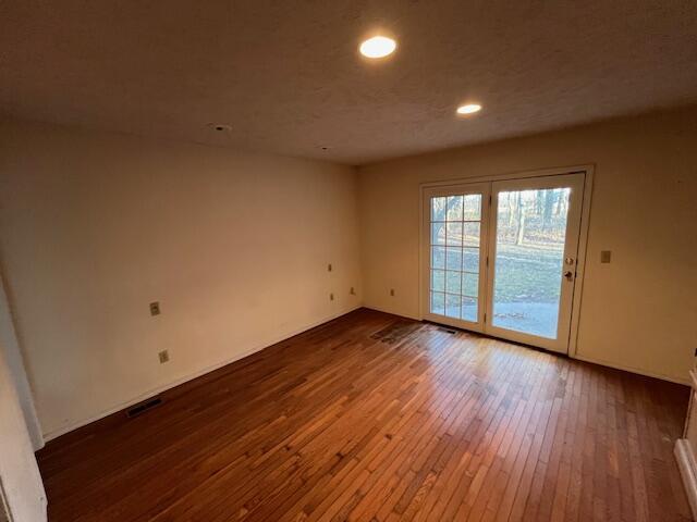 spare room with hardwood / wood-style flooring