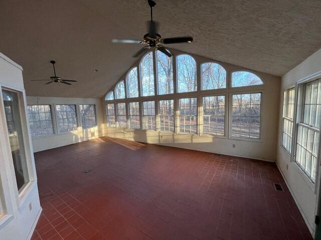 unfurnished sunroom with ceiling fan and lofted ceiling