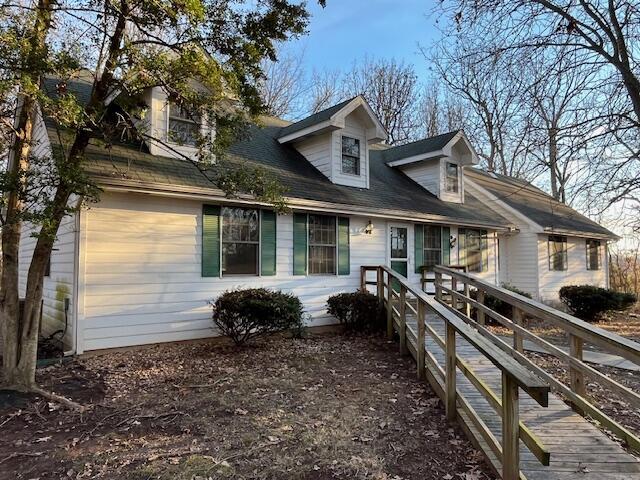 new england style home featuring a deck