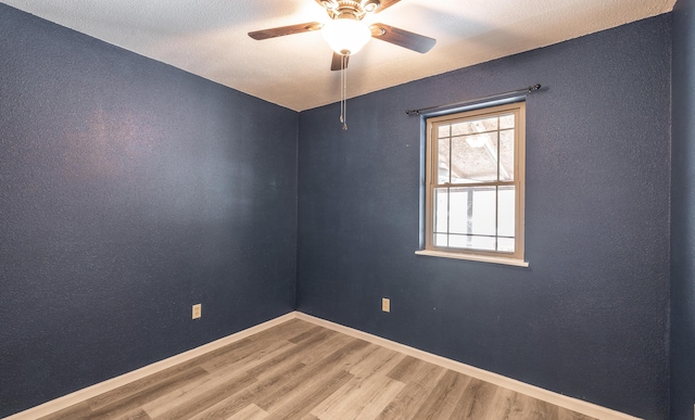 spare room with ceiling fan and wood-type flooring