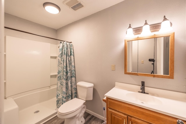 bathroom featuring toilet, vanity, hardwood / wood-style floors, and a shower with shower curtain