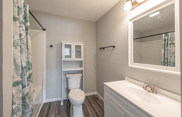 full bathroom with vanity, a textured ceiling, shower / tub combo with curtain, wood-type flooring, and toilet