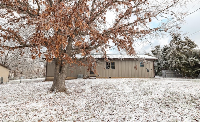 view of snow covered rear of property