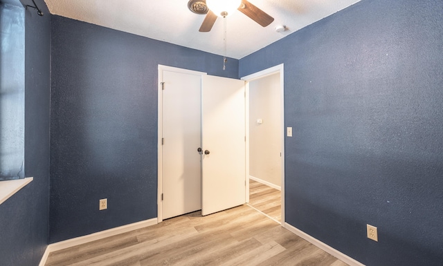 unfurnished bedroom featuring ceiling fan and light hardwood / wood-style floors