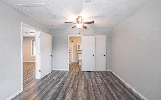 unfurnished bedroom featuring a textured ceiling, dark hardwood / wood-style floors, and ceiling fan