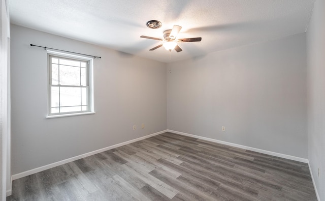 unfurnished room featuring hardwood / wood-style flooring, ceiling fan, and a textured ceiling