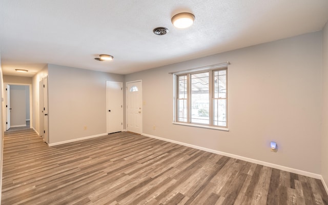 unfurnished room featuring wood-type flooring