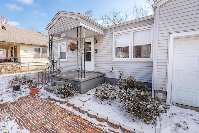 view of snow covered property entrance