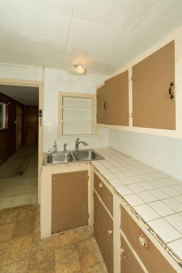 kitchen with backsplash, tile countertops, and sink