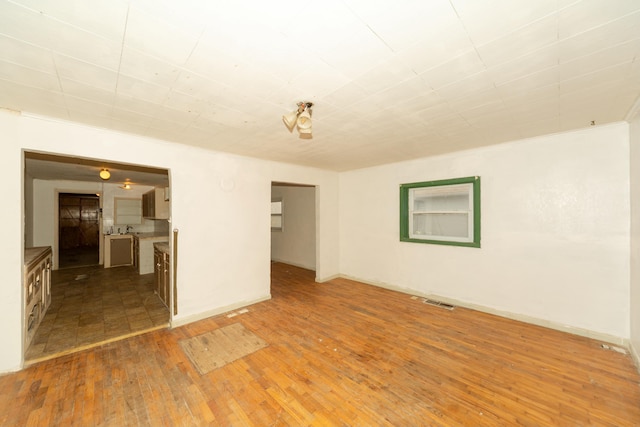 unfurnished room featuring dark hardwood / wood-style floors