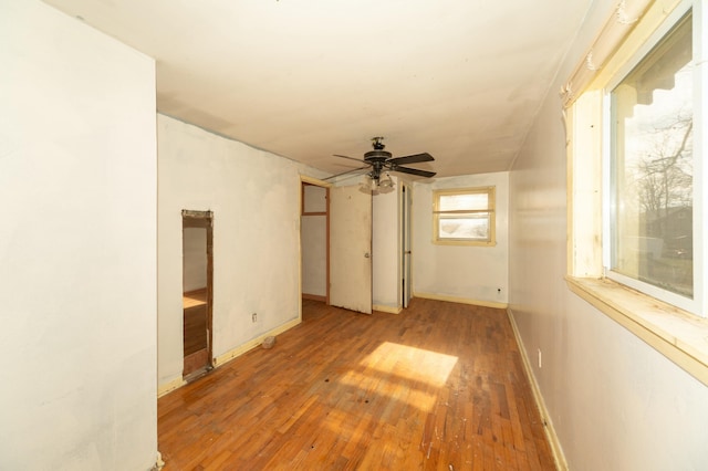 empty room with hardwood / wood-style floors and ceiling fan