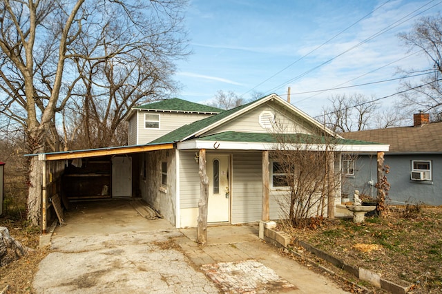 view of front of property featuring a carport and cooling unit