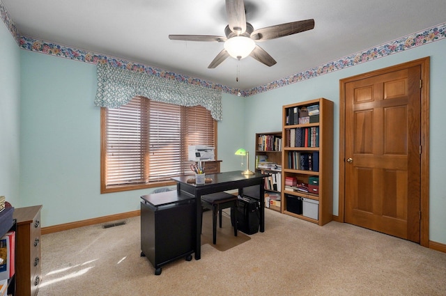 carpeted office space with ceiling fan