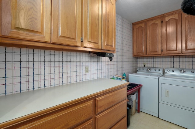 laundry area featuring cabinets and washing machine and clothes dryer