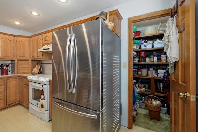 kitchen featuring stainless steel fridge and white electric stove