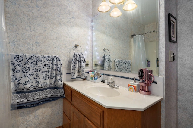 bathroom featuring a shower with curtain and vanity