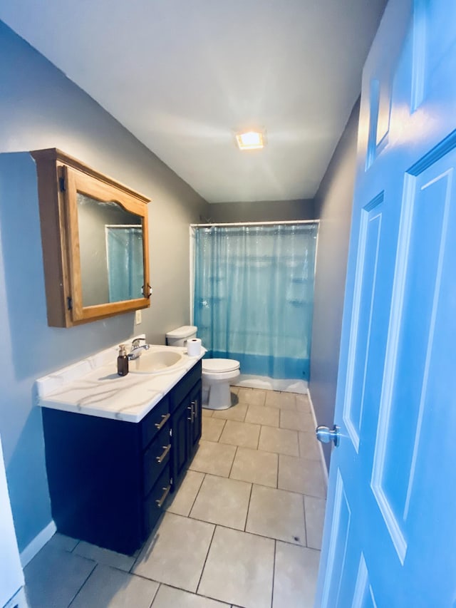 full bathroom featuring toilet, vanity, tile patterned floors, and shower / bathtub combination with curtain