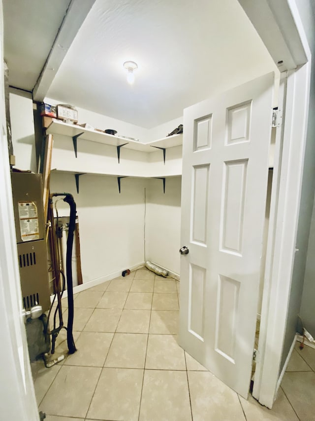 clothes washing area featuring light tile patterned floors