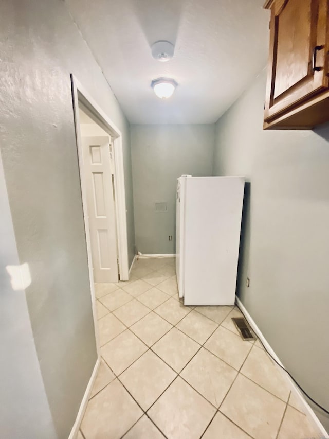 washroom with light tile patterned flooring