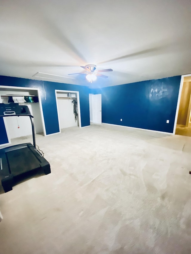 exercise room with carpet flooring and ceiling fan