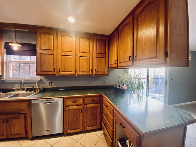 kitchen with pendant lighting, dishwasher, light tile patterned flooring, and sink