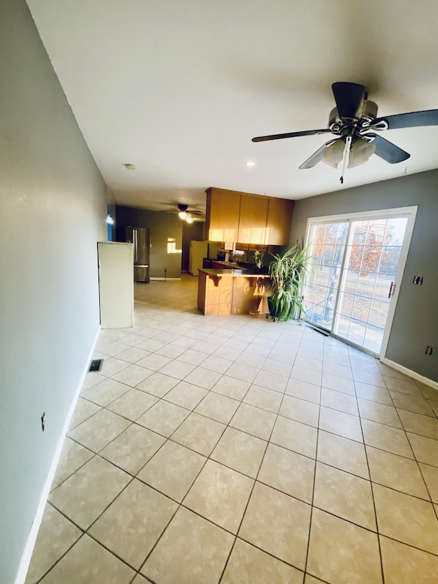 kitchen with decorative backsplash, ceiling fan, light tile patterned floors, white fridge, and stainless steel refrigerator