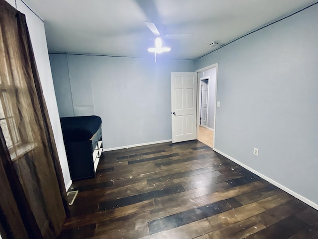 interior space with ceiling fan and dark hardwood / wood-style flooring