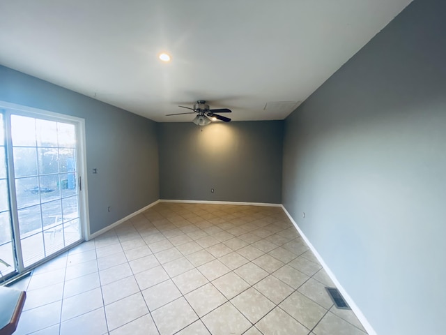 spare room with ceiling fan and light tile patterned floors