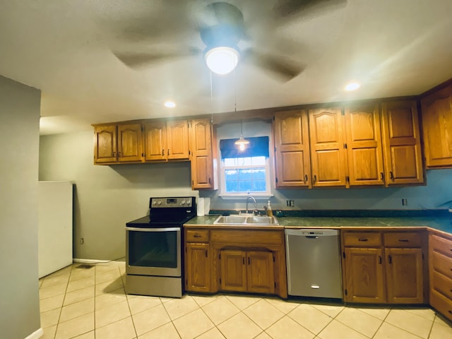 kitchen with ceiling fan, light tile patterned flooring, sink, and stainless steel appliances