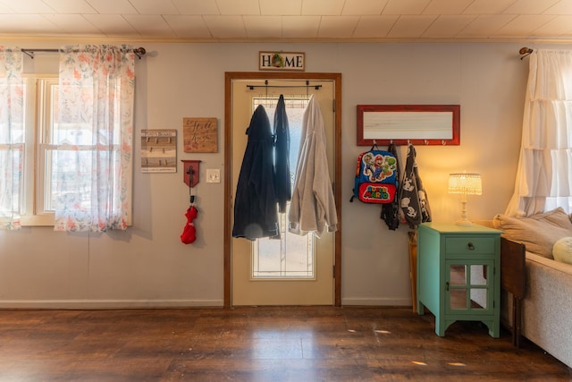 entrance foyer featuring dark wood-type flooring and ornamental molding