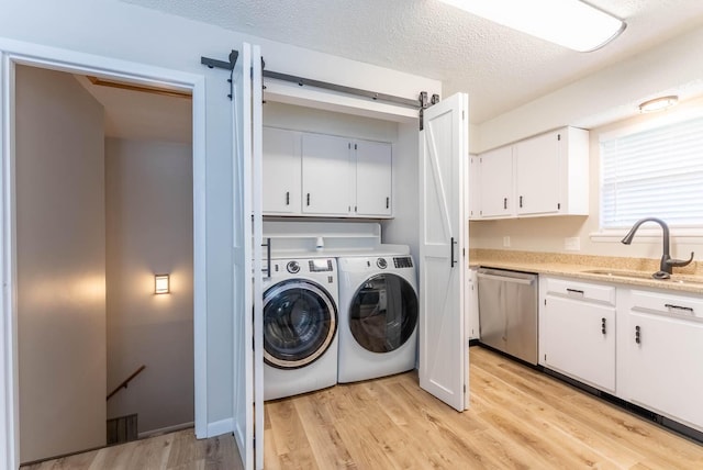1610 Good Hard Dr, West Plains, MO 65775 - laundry area with washing machine and dryer, cabinet space, light wood-type flooring, and a textured ceiling
