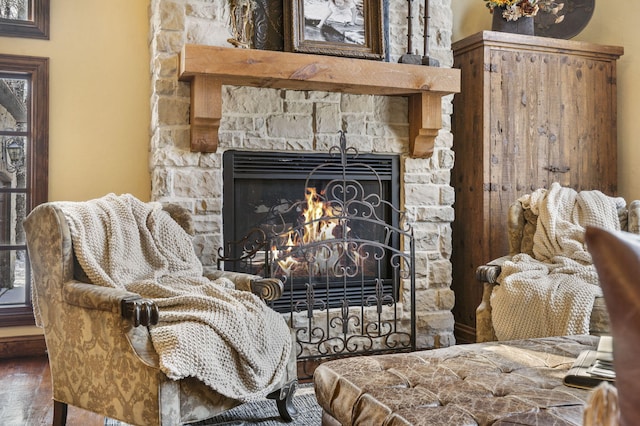 interior details with hardwood / wood-style floors and a stone fireplace