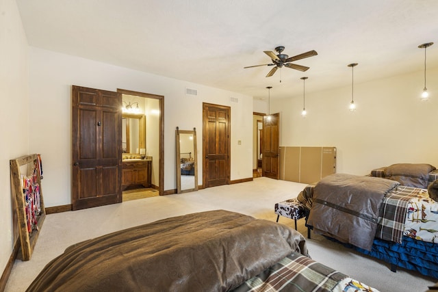 carpeted bedroom with connected bathroom and ceiling fan