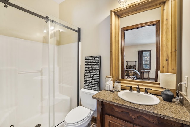 bathroom with toilet, vanity, and walk in shower