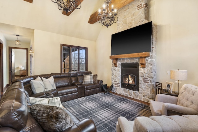 living room with an inviting chandelier, a stone fireplace, and lofted ceiling