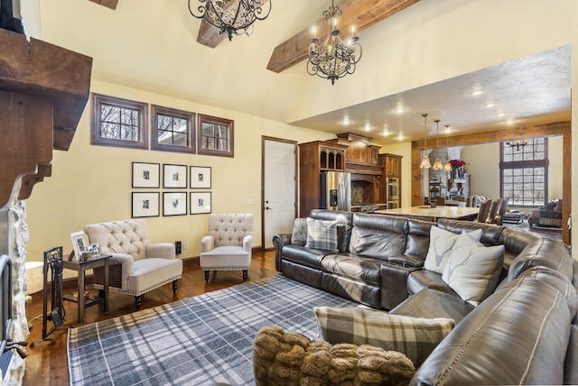 living room with beam ceiling, a towering ceiling, dark hardwood / wood-style floors, and a notable chandelier