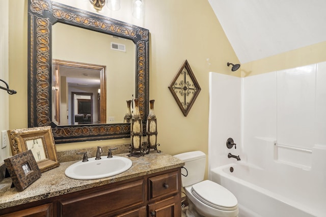 full bathroom featuring vanity, toilet, lofted ceiling, and shower / washtub combination