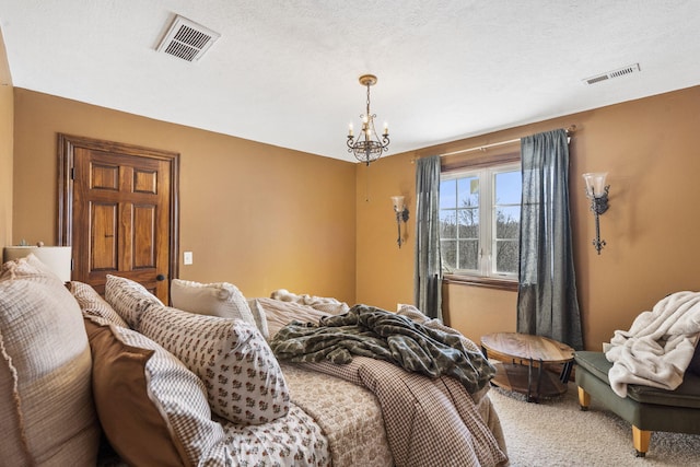 carpeted bedroom featuring a textured ceiling and a notable chandelier