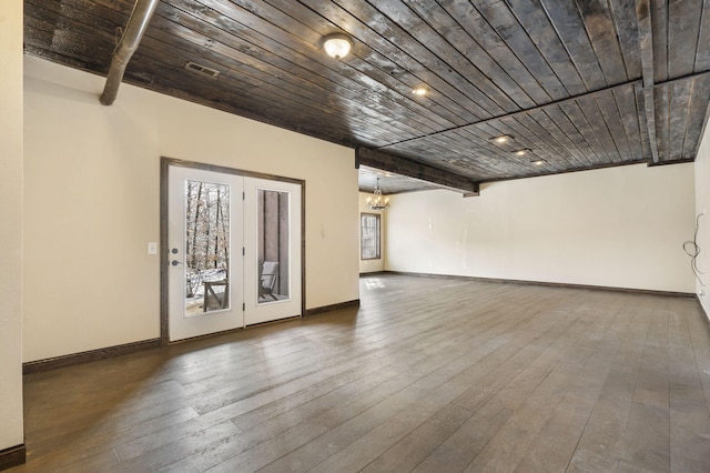 spare room with beam ceiling, a chandelier, wooden ceiling, and hardwood / wood-style flooring