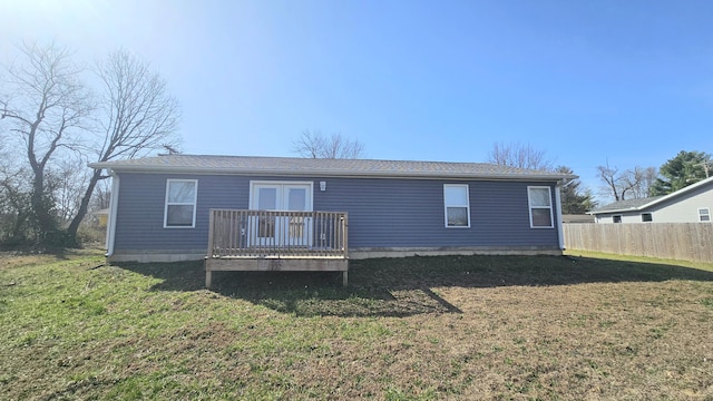 back of property featuring a deck, french doors, a yard, and fence