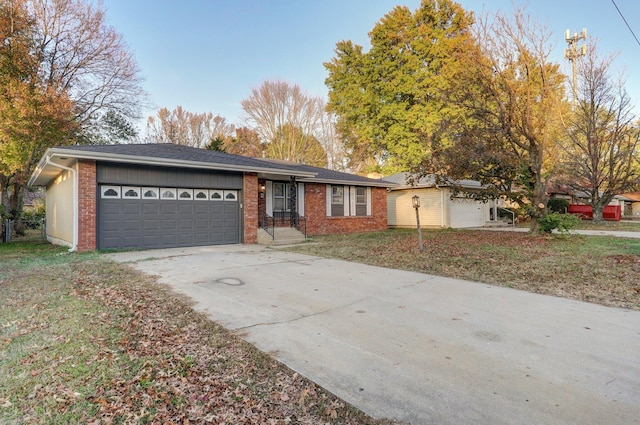 ranch-style home with a front lawn and a garage