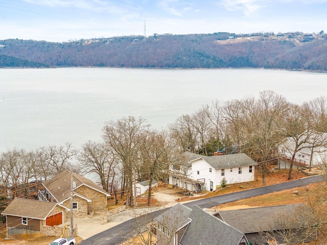 aerial view featuring a water view and a wooded view