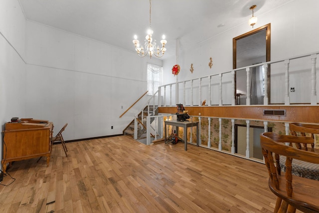 interior space featuring visible vents, a notable chandelier, stairway, and wood finished floors