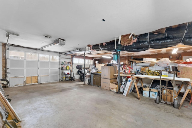 garage with a workshop area and a garage door opener