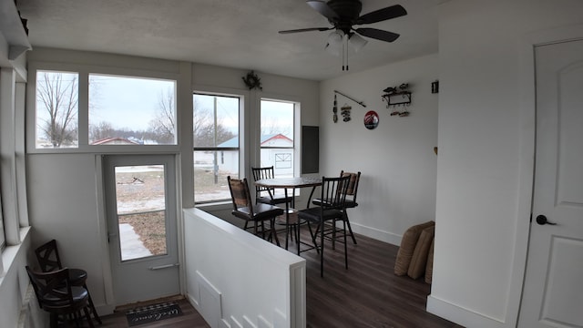 dining area featuring ceiling fan and dark wood-type flooring