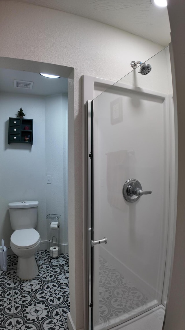 bathroom with tile patterned flooring and walk in shower