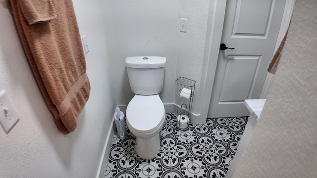 bathroom featuring tile patterned flooring and toilet